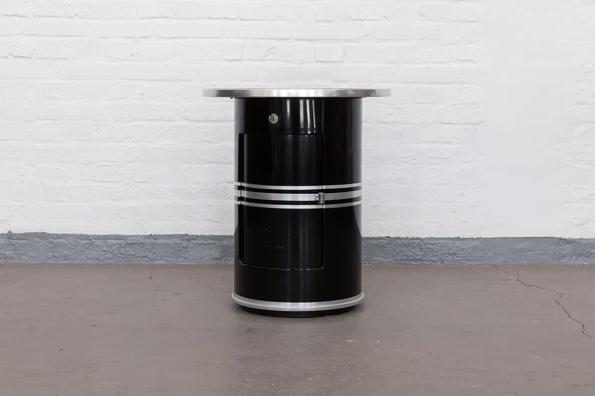 Original 1939 barrel table by Alfons Mauser Werke, model Tanger/S. Black-lacquered steel, aluminium rings, grey linoleum top, and red felt-lined rotating interior. A collector’s piece of German Modernism.
