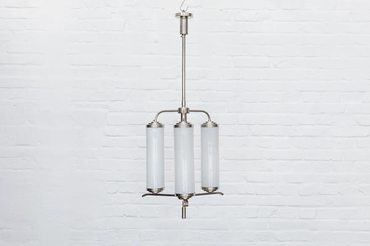 kademo-store-modernist-chandelier-deckenleuchte-nickel-opalglas-1930s-151I01 1930s modernist chandelier made of nickel-plated brass with three vertically arranged cylindrical shades in opalglas; a striking example of functional yet decorative German lighting design.
