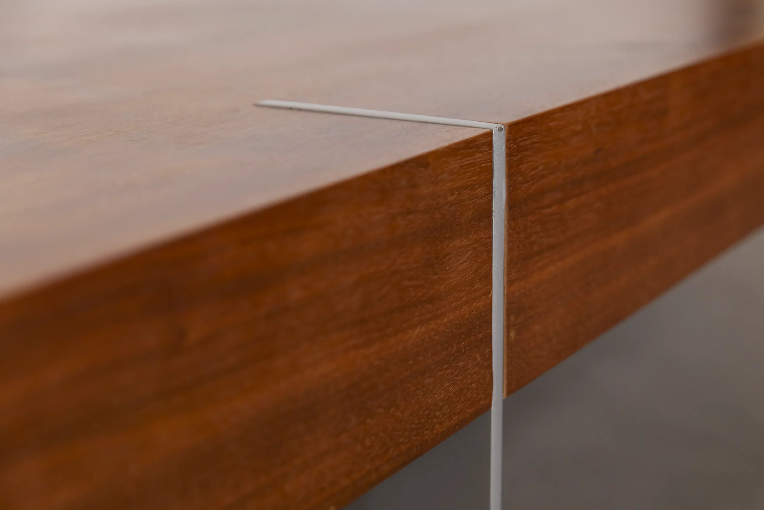 1960s International Style sofa table with walnut veneer top and flat-steel base, combining warm wood tones with minimalist modern design.