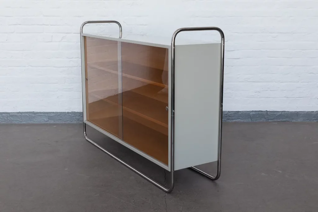 Tubular steel sideboard in Bauhaus style, crafted in small series. Polished steel frame, grey lacquered surfaces, sliding glass doors. In stock and customizable with individual finishes.