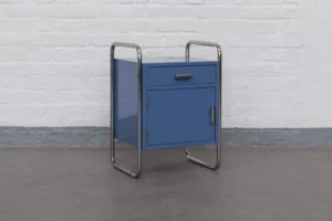 Thonet Bauhaus bedside cabinet from the 1930s with chromed tubular steel frame, lacquered body in original Bauhaus blue and cylindrical Bauhaus-style handles — restored to museum standards.