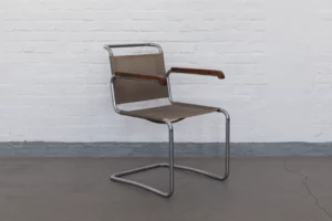 Early 1930s cantilever chair model H164 by Jindřich Halabala, produced by UP závody Brno. Chromed tubular steel frame with solid wood armrests and original Eisengarn upholstery in museum-grade condition.