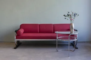 Tubular steel daybed couch by Hynek Gottwald, Czechoslovakia 1930s, chromed tubular steel frame on high-gloss lacquered wooden sled bases with red upholstery.
