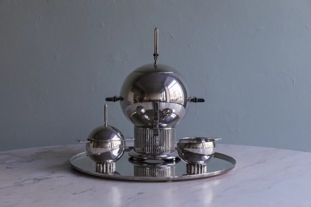 Original Alessi samovar set in 925 silver designed by Eliel Saarinen featuring spherical samovar, sugar bowl, milk jug and original tray.