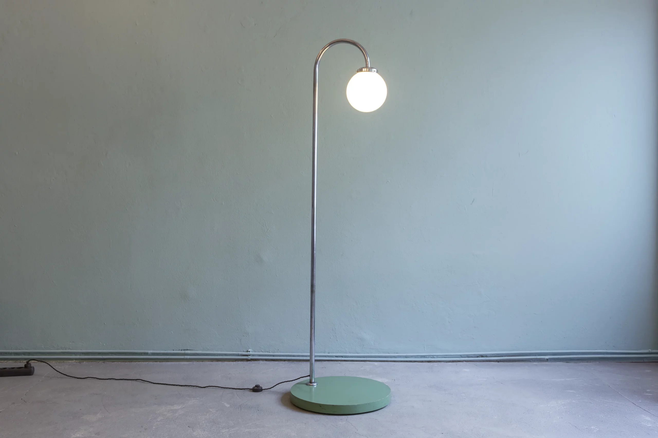 Avant-garde floor lamp from 1930s Czechoslovakia with an original reseda green base, chromed tubular steel frame and opal glass globe in the style of Czechoslovak Functionalism.
