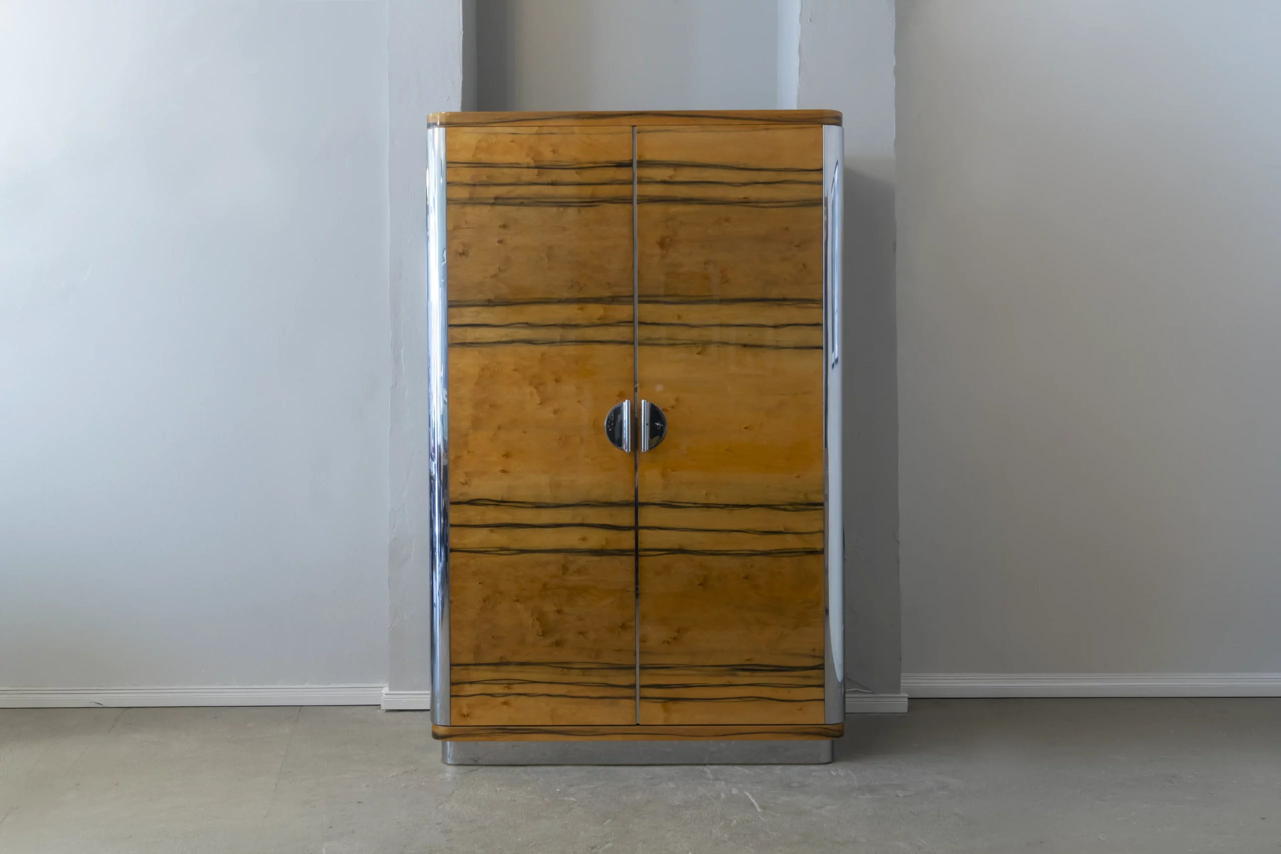 Custom wardrobe cabinet inspired by Classical Modernism featuring birch veneer, hand-painted decoration, polished stainless steel details and a customisable interior.